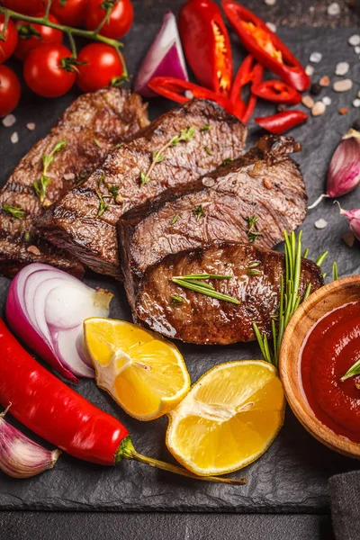 Izgara Dana biftek baharat ve sebzeler kayrak Yönetim Kurulu, koyu arka plan, makro ile