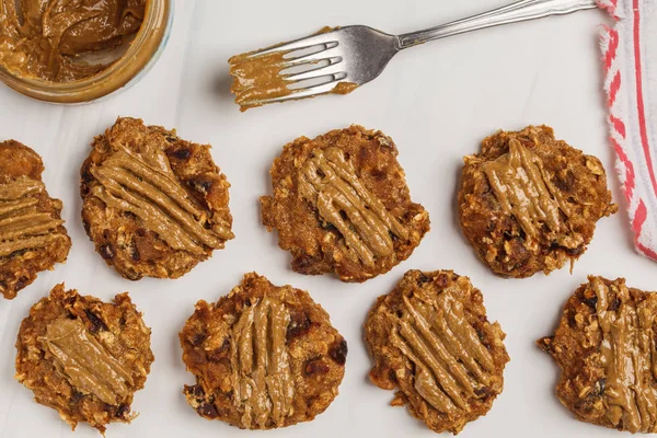 Vegan oatmeal cookies with peanut butter on white background, top view. Healthy vegan food concept.