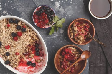 Kahve ile kahvaltı ve parçalamak pasta, koyu arka plan, sağlıklı kahvaltı kavramı, üstten görünüm. Vegan berry tatlı.