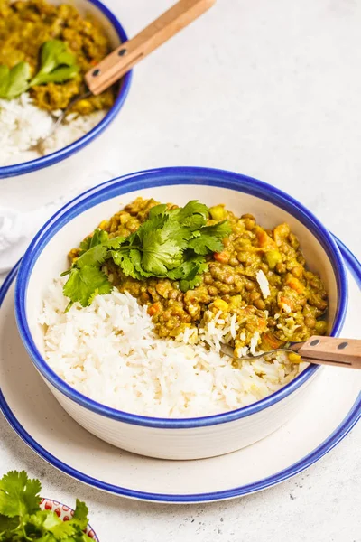 Lentil curry with rice, Indian cuisine, tarka dal, white background. Vegan food. Clean eating concept.