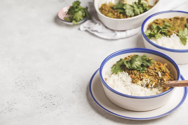 Lentil curry with rice, Indian cuisine, tarka dal, white background. Vegan food. Clean eating concept.