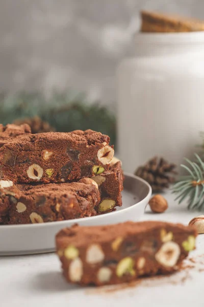 Italian Christmas dessert panforte with nuts, chocolate and candied fruits. Christmas background, Christmas dessert concept.