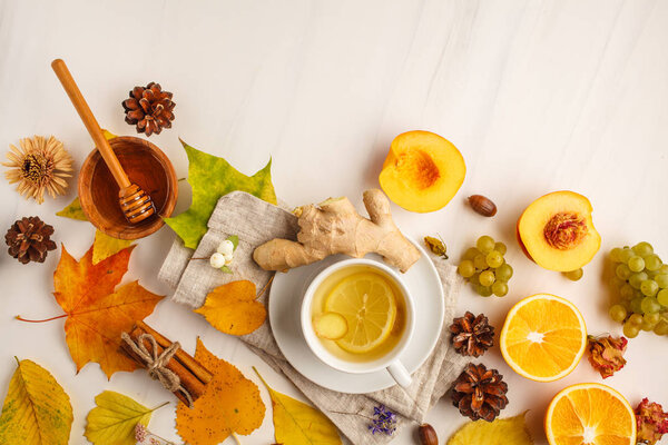 Autumn tea, autumn fruits and decorations on a white background. Autumn background.