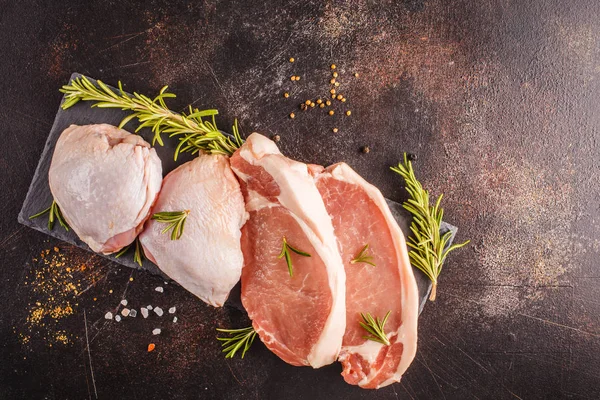 Çiğ tavuk ve domuz etinin barut baharatlar ile. Koyu arka plan, üstten görünüm alanı kopyalayın. Gıda arka plan.