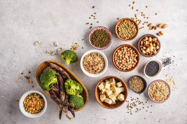 Vegan protein source. Tofu, beans, chickpeas, nuts and seeds on a white background, top view, copy space. Healthy vegetarian food concept.