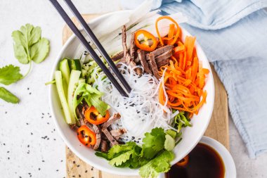 Topuz cha salata kasesi. Vietnamca pirinç noodle ile sığır eti ve kırmızı biber sebze salatası beyaz kase, üst görüntülemek.