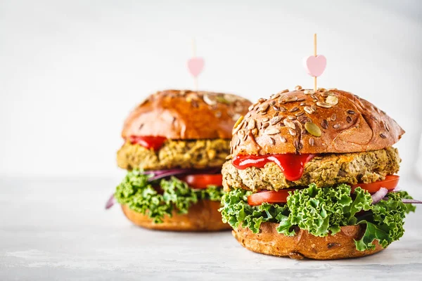 Vegan lentil burgers with kale and tomato sauce on a white background. Plant based food concept.