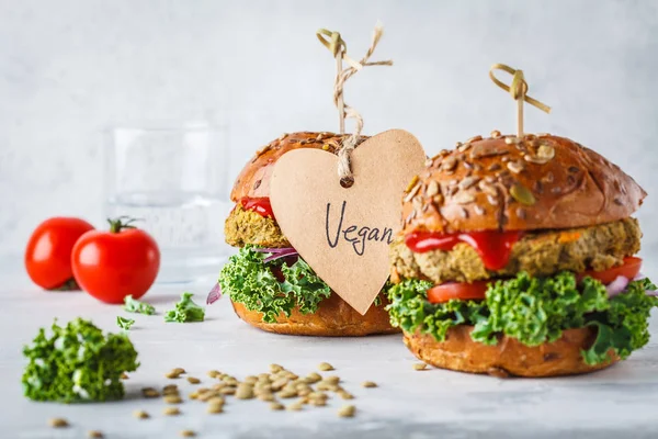 Vegan lentil burgers with kale and tomato sauce on a white background. Plant based food concept.