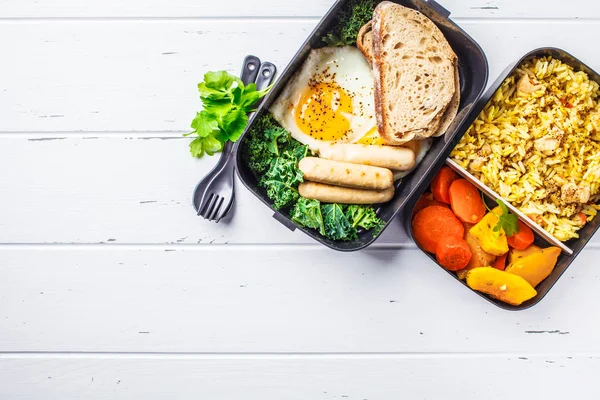 Yemek hazırlık kapları ile pişmiş sebze, yumurta, sosis ve salata kahvaltı ve ek yükü vurdu, öğle yemeği için tavuk, pilav yer, wtite ahşap arka plan kopyalama.