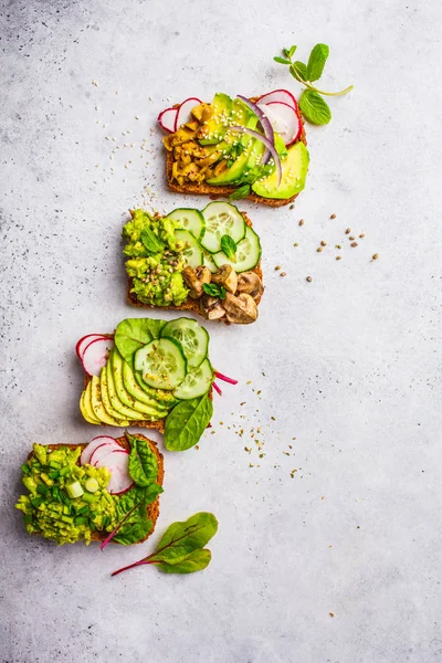 Avokado tost farklı soslar, üstten görünüm, beyaz arka plan ile. Bitki esaslı diyet kavramı.
