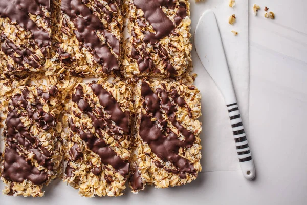 Homemade chocolate oat bars on a white background. Healthy vegan dessert, detox food, plant based.