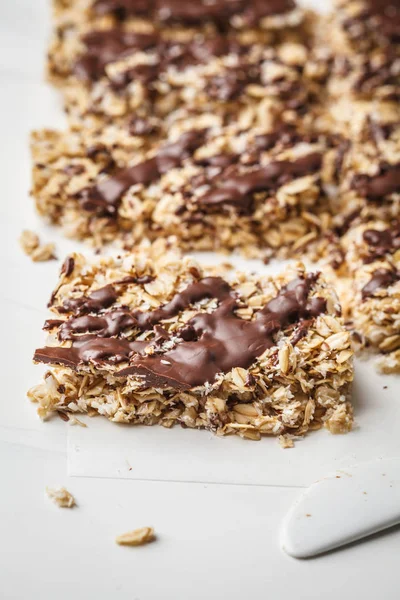 Homemade chocolate oat bars on a white background. Healthy vegan dessert, detox food, plant based.