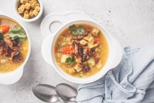Split pea soup with smoked bacon and crackers in a white plate. — Stock Image Split Pea Soup Smoked Bacon Crackers White Plate Royalty Free Stock Images