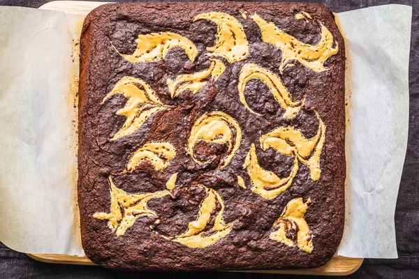 Vegan brownie with peanut butter on white background.