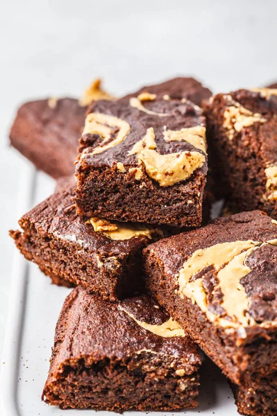 Vegan brownie with peanut butter on white background.