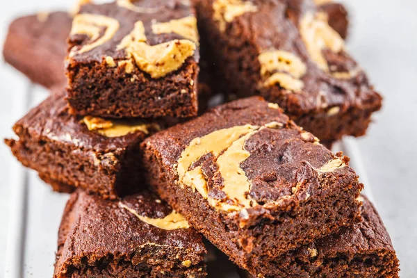 Vegan brownie with peanut butter on white background.