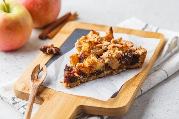 Piece of vegan apple pie with cinnamon and dates. Vegan food con