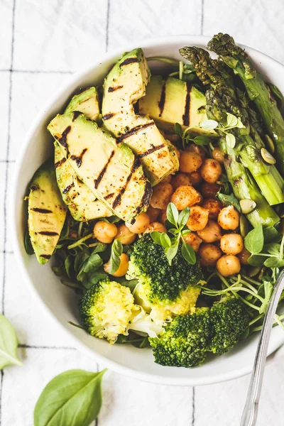 Buddha bowl with grilled avocado, asparagus, chickpea