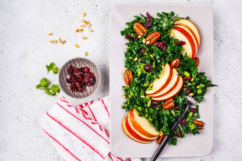 Healthy vegan salad with apple, cranberry, kale and pecan