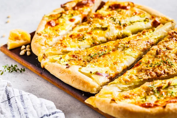 Vegetarian pizza with zucchini, cheese and nuts. Healthy food co