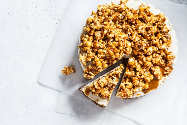 Raw vegan cashew cheesecake with caramel popcorn, top view.