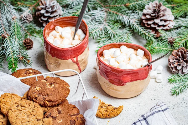 Christmas background. Winter cocoa with cookies in a Christmas decoration on a gray background.