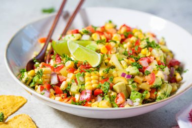Mexican corn salad in a white plate. Mexican food concept. clipart
