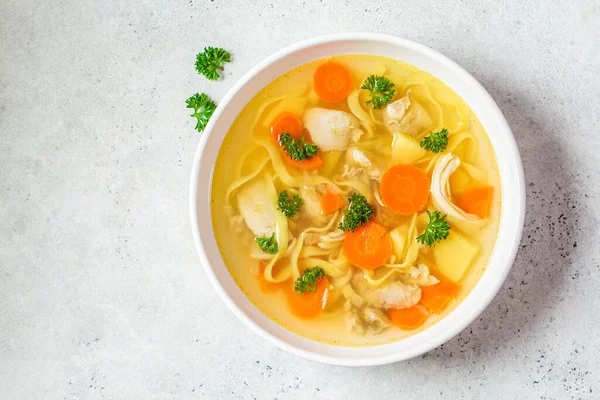 Homemade chicken soup with noodles and vegetables in a white bowl, white background. Healthy warm comfortable food. — Stock Image Homemade Chicken Soup Noodles Vegetables White Bowl White Background Healthy Stock Image