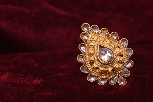花式设计师珍贵的珠宝金色戒指特写镜头宏观图像在红色背景上的女人 — 图库照片