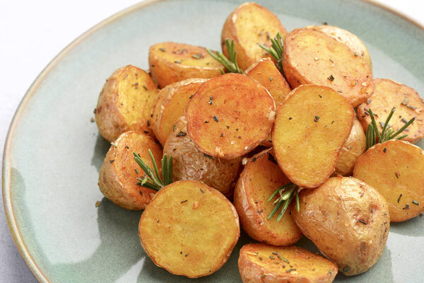 delicious baked potatoes on a rustic green plate.