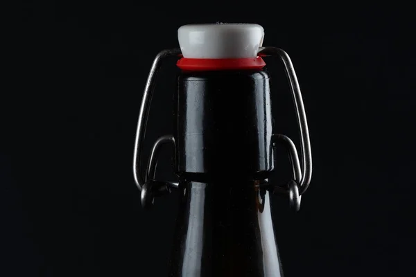 Beer bottle with lid dark glass on a dark background — Stock Photo, Image