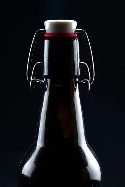 Beer bottle with lid dark glass on a dark background — Stock Photo, Image