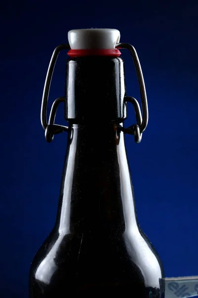 Beer bottle with lid dark glass on a dark background — Stock Photo, Image