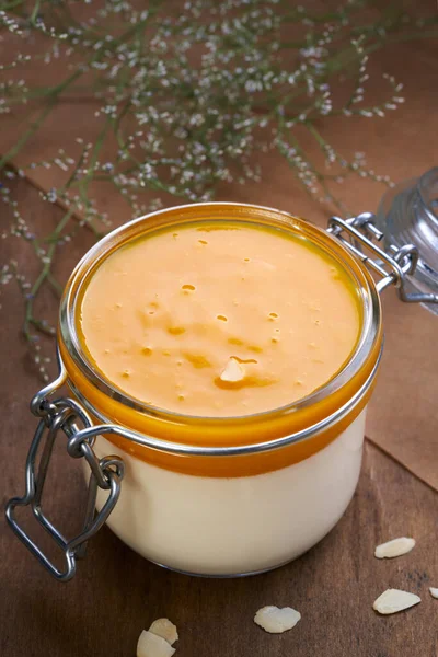 Yogurt with mango jam in a glass jar — Stock Photo, Image