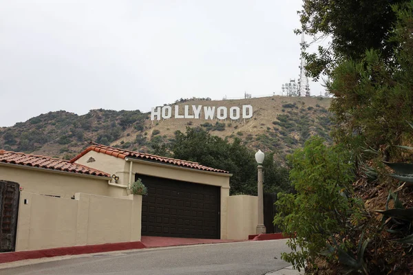Hollywood Sign in Griffith Park Los Angeles California USA on July 26 2025 - Beautiful Scenic View of the Hollywood Sign and Los Angeles Hills at Daytime Next to a House
