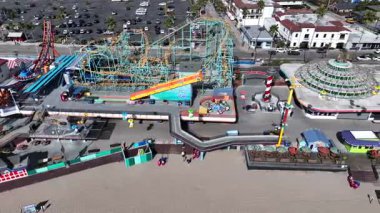 Santa Cruz, California, USA on January 10 2025: Aerial Drone Footage of Santa Cruz, the Boardwalk Amusement Park Captures Coastal Views, Roller Coaster Rides, Crowds and Arcade on a Gloomy Day
