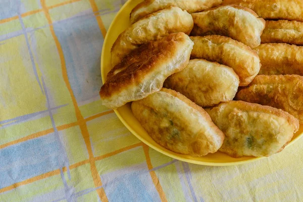 Fresh fried small handmade patties with green onions and egg on a plate. Tablecloth — Stock Photo, Image