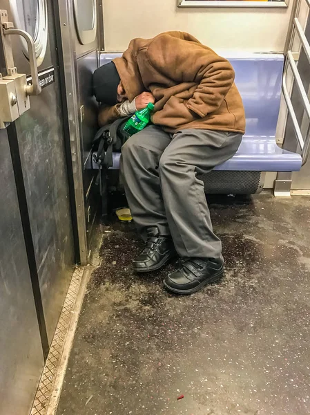 Manhattan, NY US - February 7, 2018 Homeless person sleeps in a subway car — Stock Photo, Image