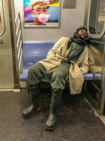 Manhattan, NY US - March 14, 2018 Homeless person sleeps in a subway car — Stock Photo, Image