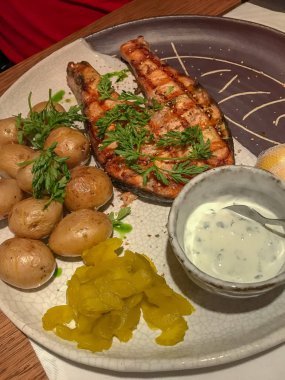 Küçük soyulmamış haşlanmış patates ile ızgara somon.