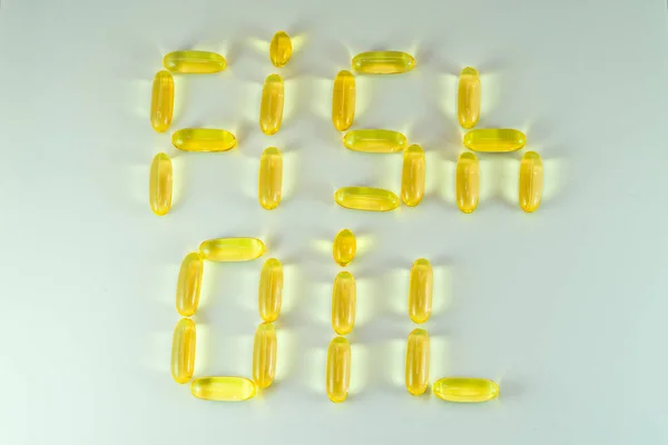 Top view of Fish oil capsules on white background. Omega 3. Vitamin E. Supplement food for good life — Stock Photo, Image