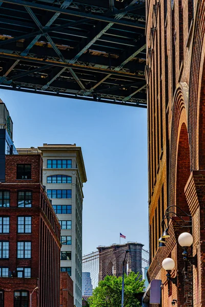 Plymouth St debajo del puente Manhattan con vista al elemento del puente Brooklyn con bandera america. — Foto de Stock
