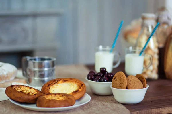 The perfect morning breakfast for the mum and her little son. Milk and buns with cream. Fantastic morning for two