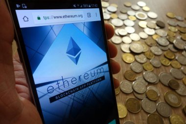 Konskie, Polonya - 08 Mayıs 2018: smartphone ve sikke yığını üzerinde görüntülenen Ethereum cryptocurrency Web sitesi