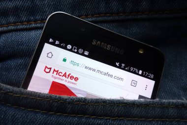 KONSKIE, POLAND - MAY 16, 2018: McAfee website displayed on Samsung smartphone hidden in jeans pocket clipart