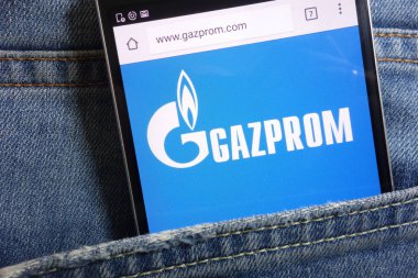 KONSKIE, POLAND - MAY 18, 2018: Gazprom website displayed on smartphone hidden in jeans pocket clipart