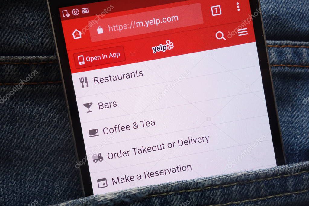 KONSKIE, POLAND - MAY 19, 2018: Yelp website displayed on smartphone hidden in jeans pocket
