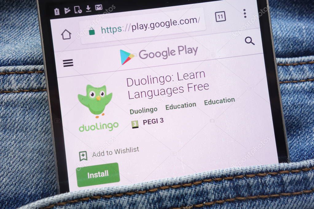 KONSKIE, POLAND - JUNE 09, 2018: Duolingo app on Google Play website displayed on smartphone hidden in jeans pocket