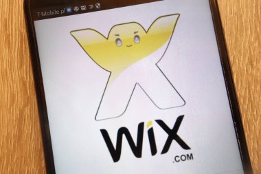 KONSKIE, POLAND - SEPTEMBER 01, 2018: Wix.com logo displayed on a modern smartphone clipart