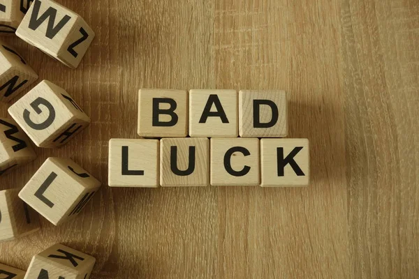 Bad luck text from wooden blocks on desk